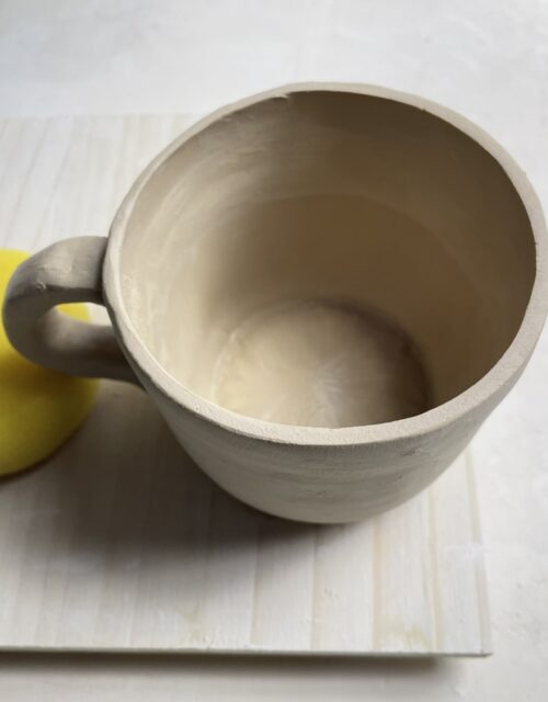 handmade ceramic mug in neutral glaze high-fired pottery bowl studio shot ceramic plate natural light photography
