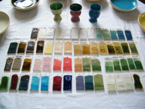 flat lay of different pottery samples showing glaze swatches with labels.