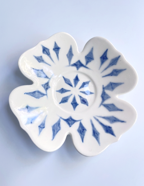 Underglaze decorated clover shaped small saucer
