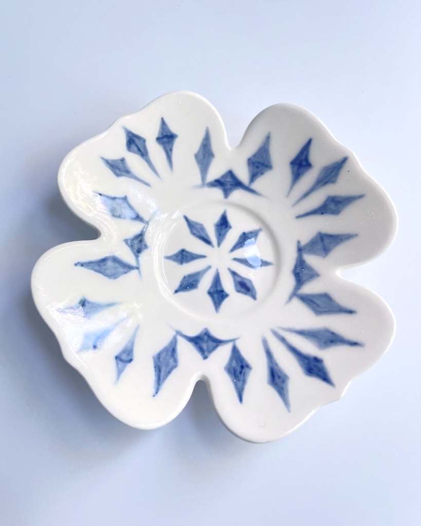 Underglaze decorated clover shaped small saucer