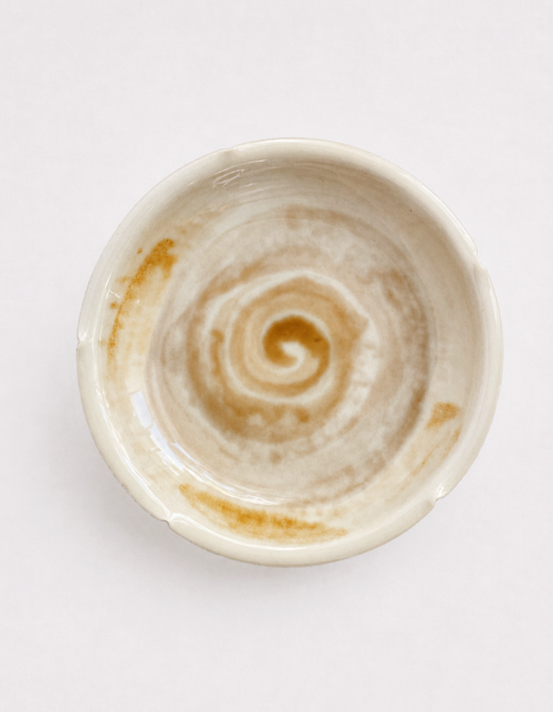 Spiral motif ceramic saucer