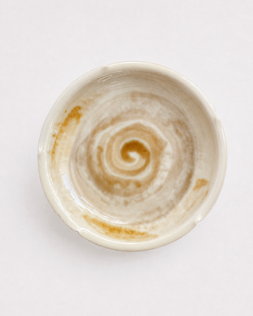 Spiral motif ceramic saucer