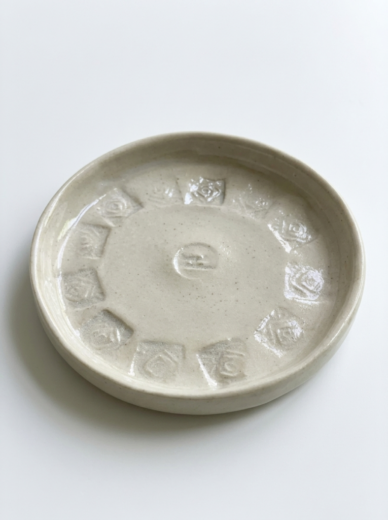 Stamped ceramic saucer